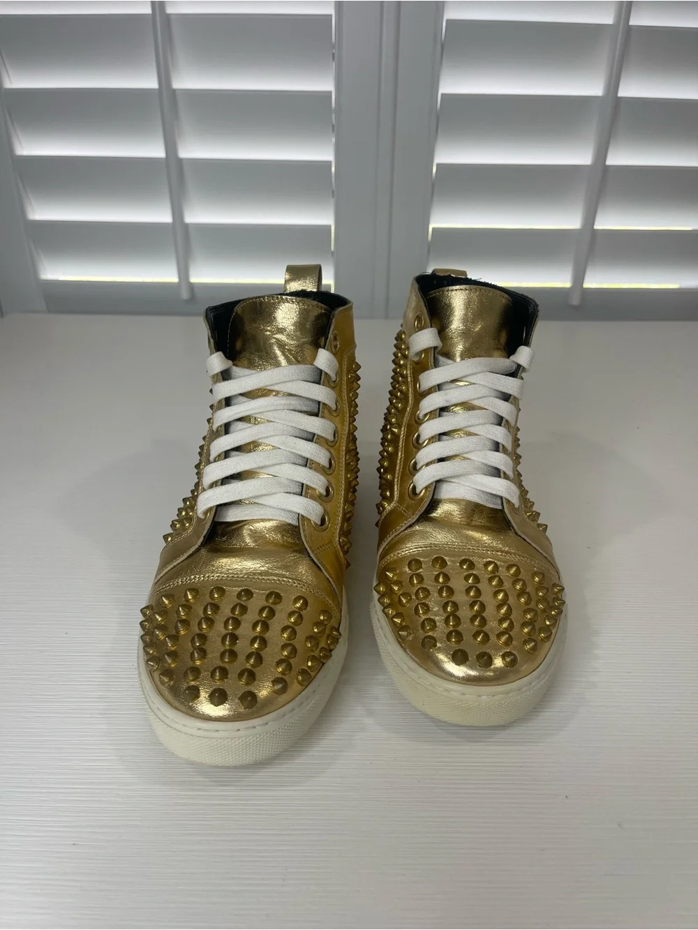 Metallic Gold High-Top Sneakers with Stud Details by Rodney P. Hunt